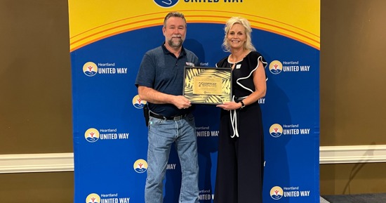 Jay Wren accepts Oustanding Community Champion Award with HUW President Karen Rathke